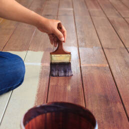 Varnishing wood floorboards